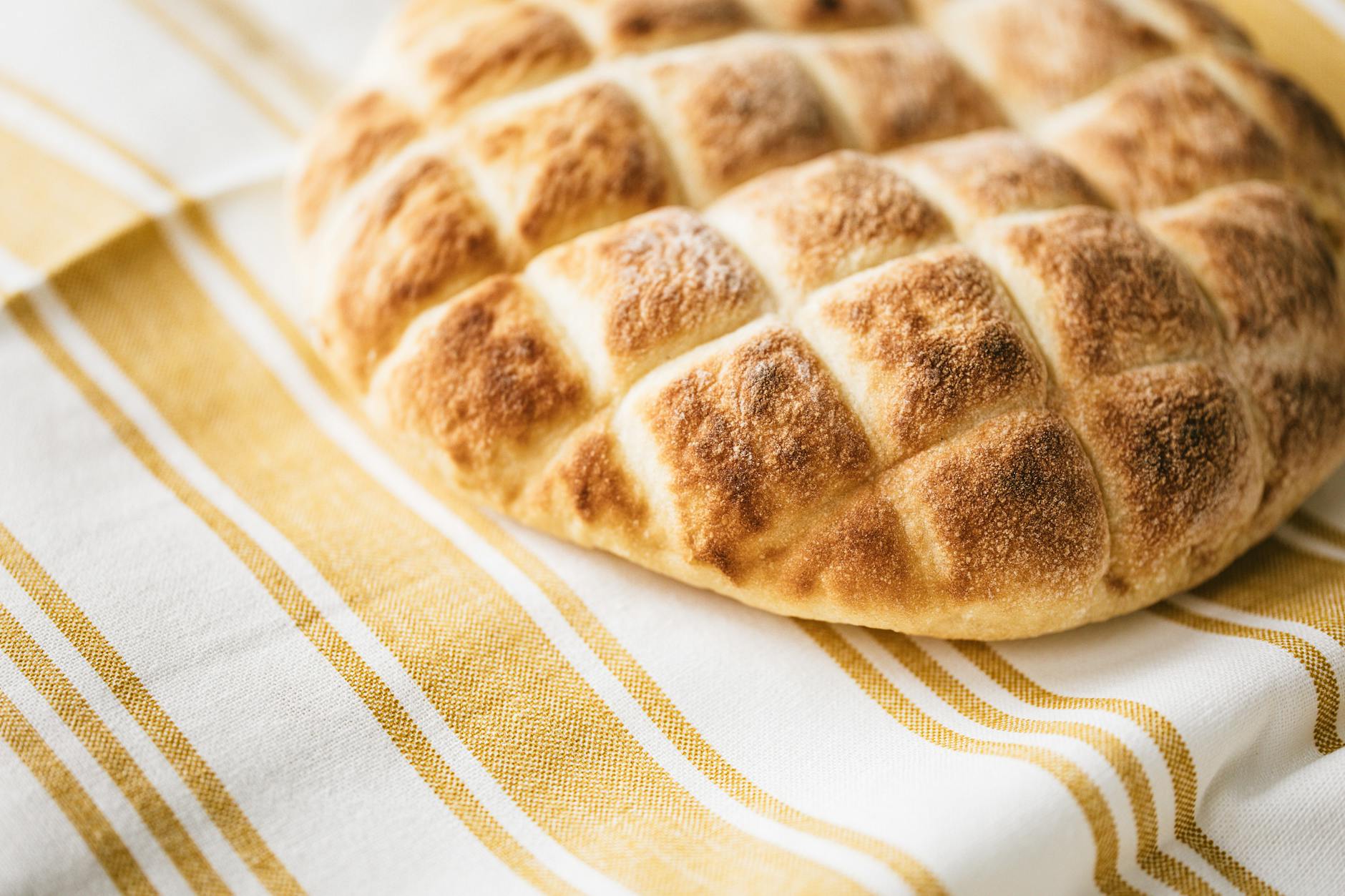 fresh baked bread on striped tablecloth