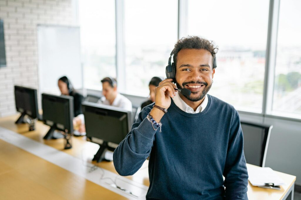 man in blue sweater using headphones